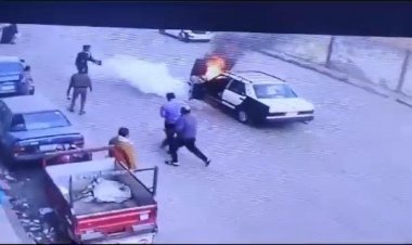 صور| بطولة أمين شرطة تنقذ قائد سيارة مشتعلة في ميدان المحطة بأسيوط